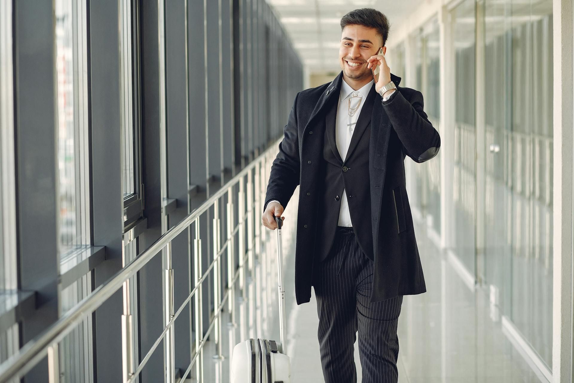 Business traveller smiling while on a call.
