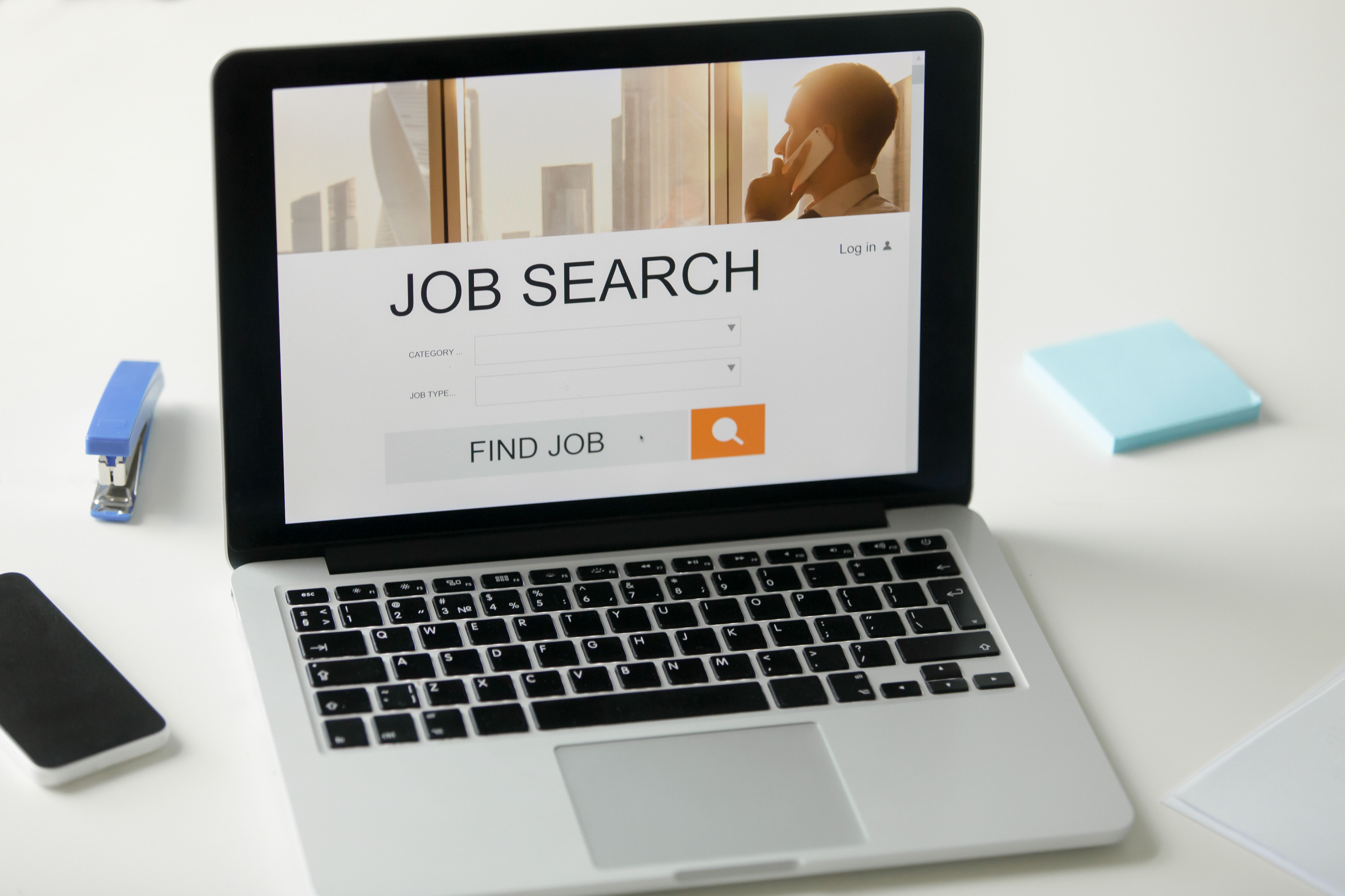 Laptop on a desk showing a job search site,  an important tool for writing a formal letter format in Malaysia.