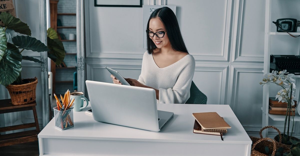 Woman at desk working with a laptop