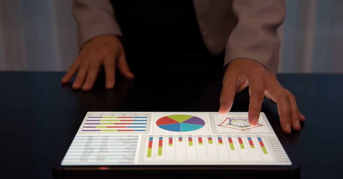 Employee reviewing commission report on a tablet