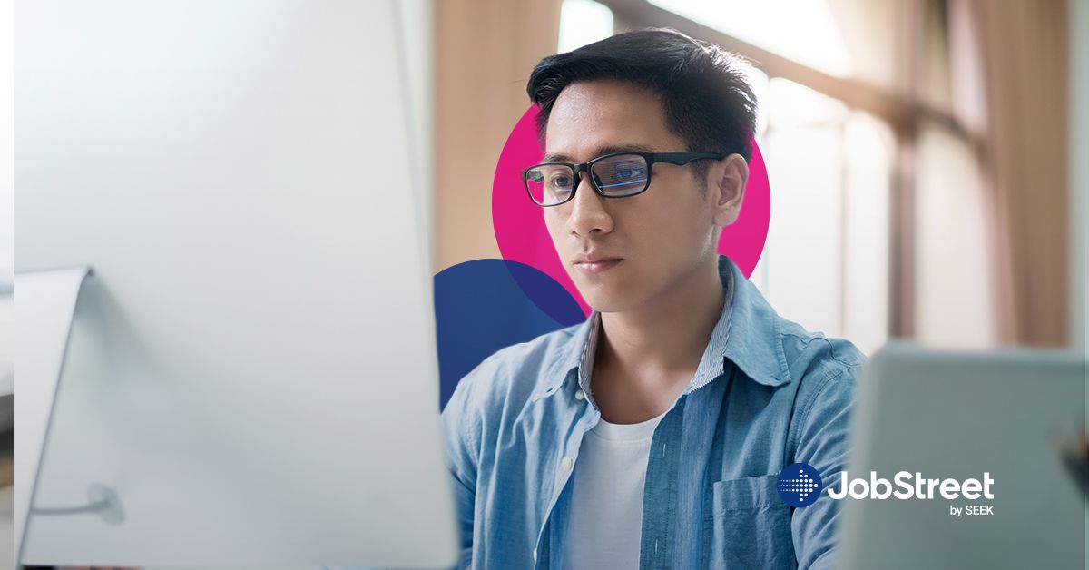 A guy seated in front of a laptop, concentrating on the screen, reading and analyzing information