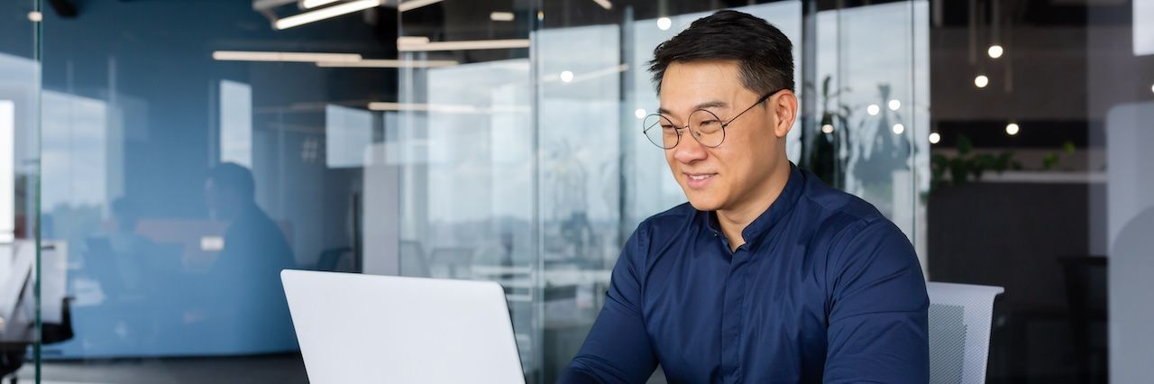 man working on laptop in an office