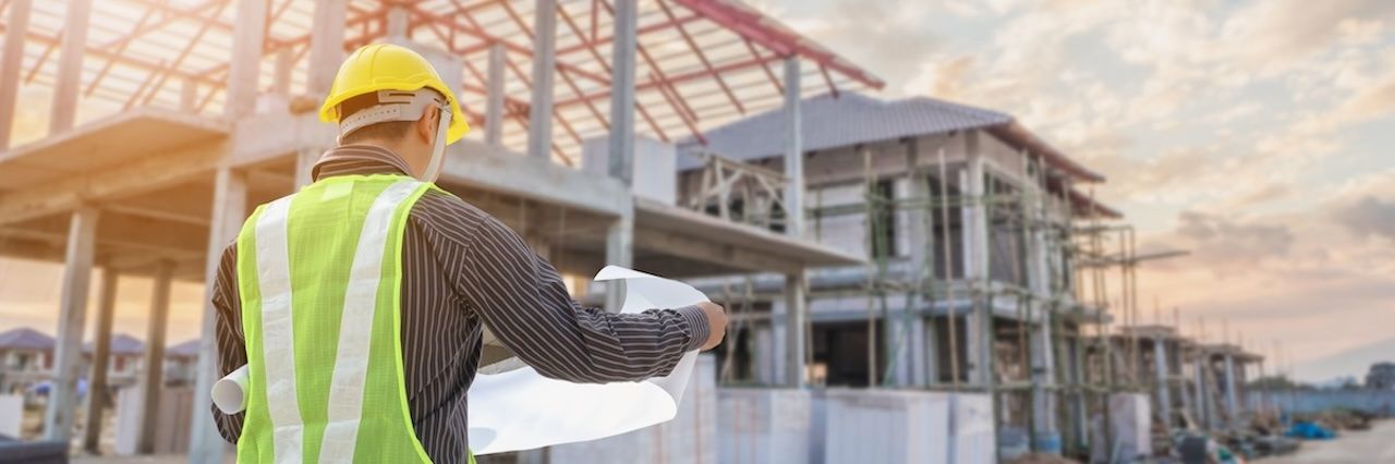 construction worker at a jobsite looking at plans