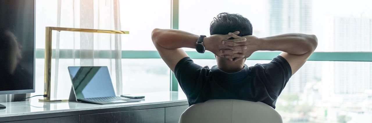 Man at a desk looking at a window