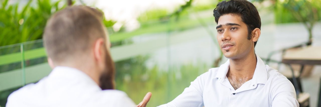 two men in business meeting outside