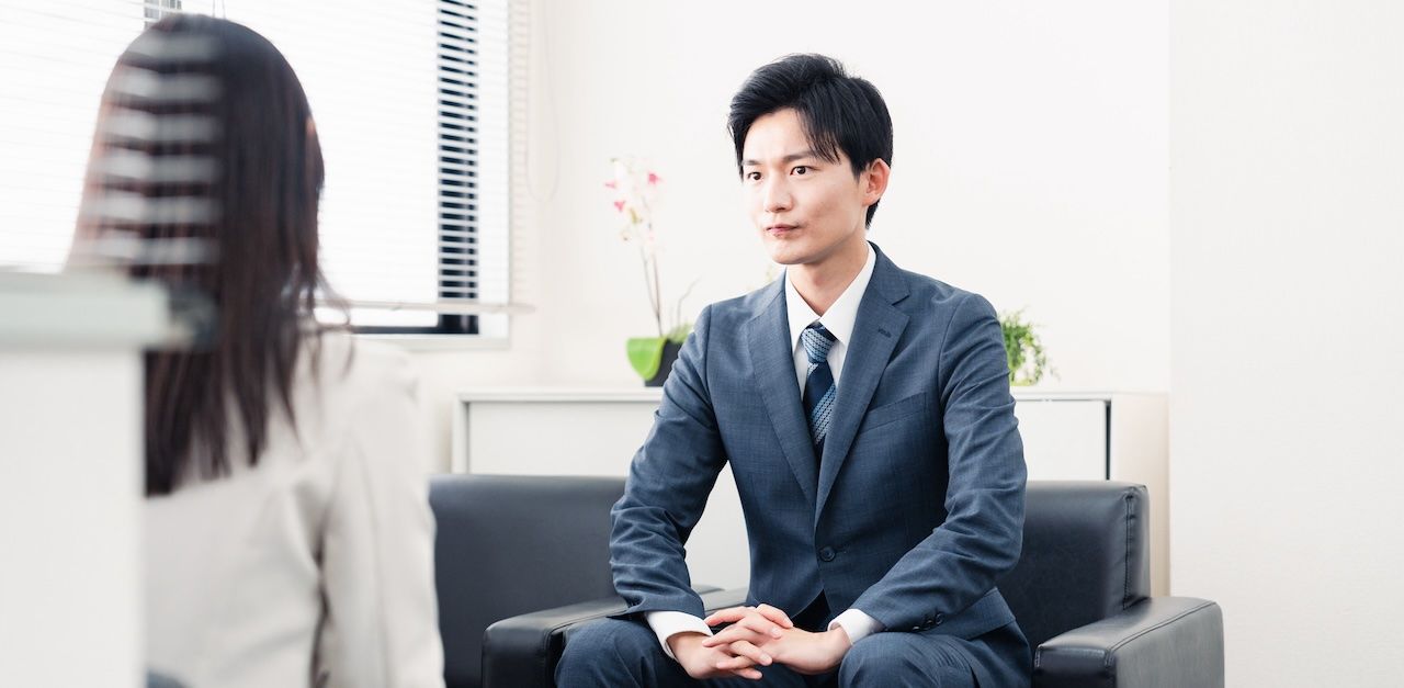 Man in a suit during an interview with a woman