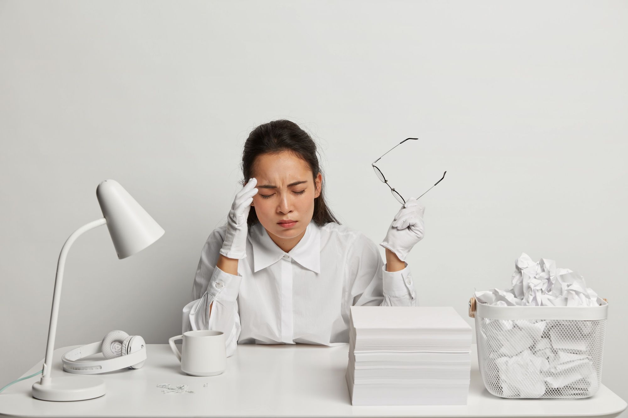 Young woman working at her desk, thinking about debit and credit in bookkeeping