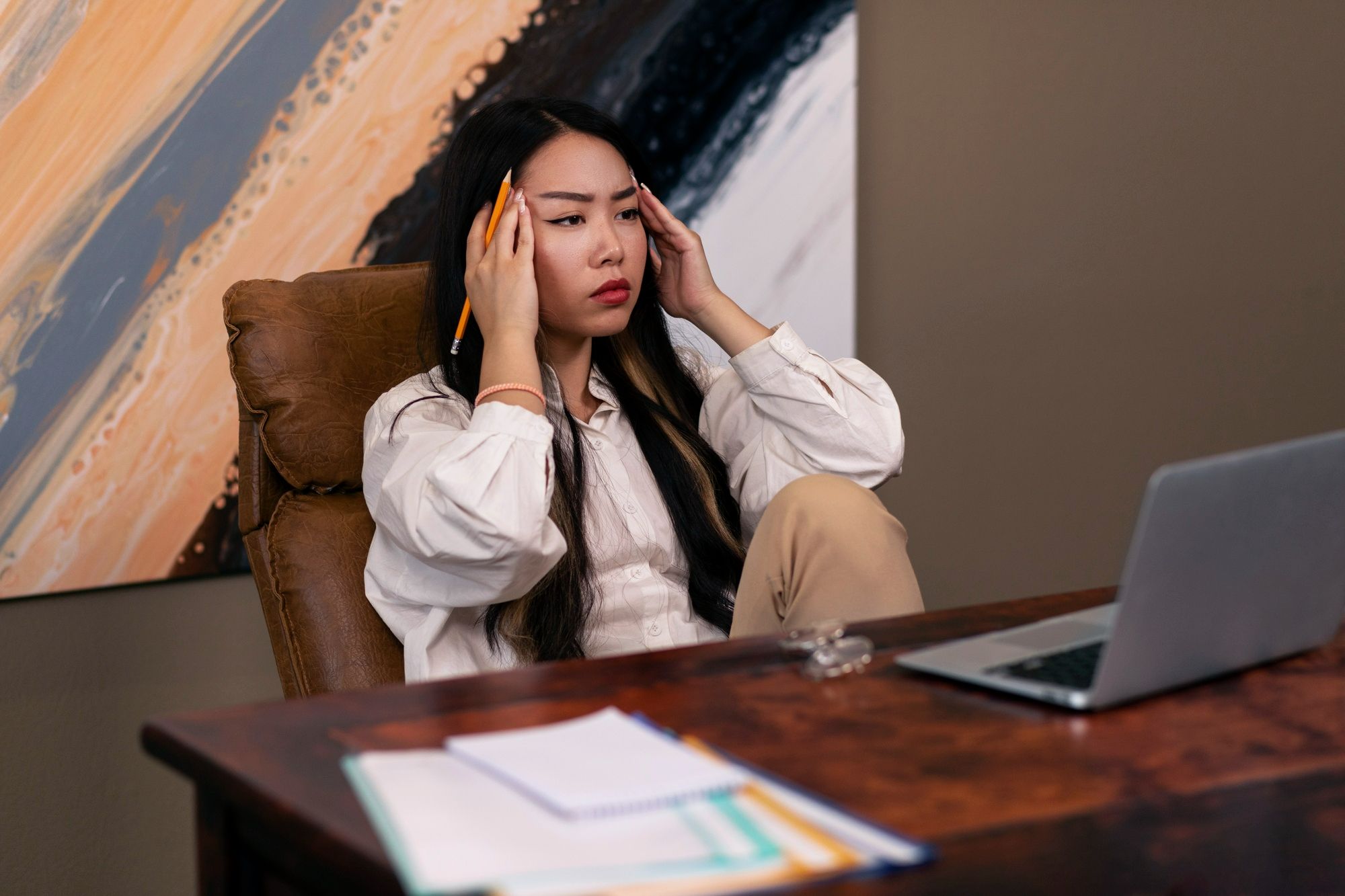 A young female job applicant thinking about the common applicant tracking system (ATS) resume errors to avoid