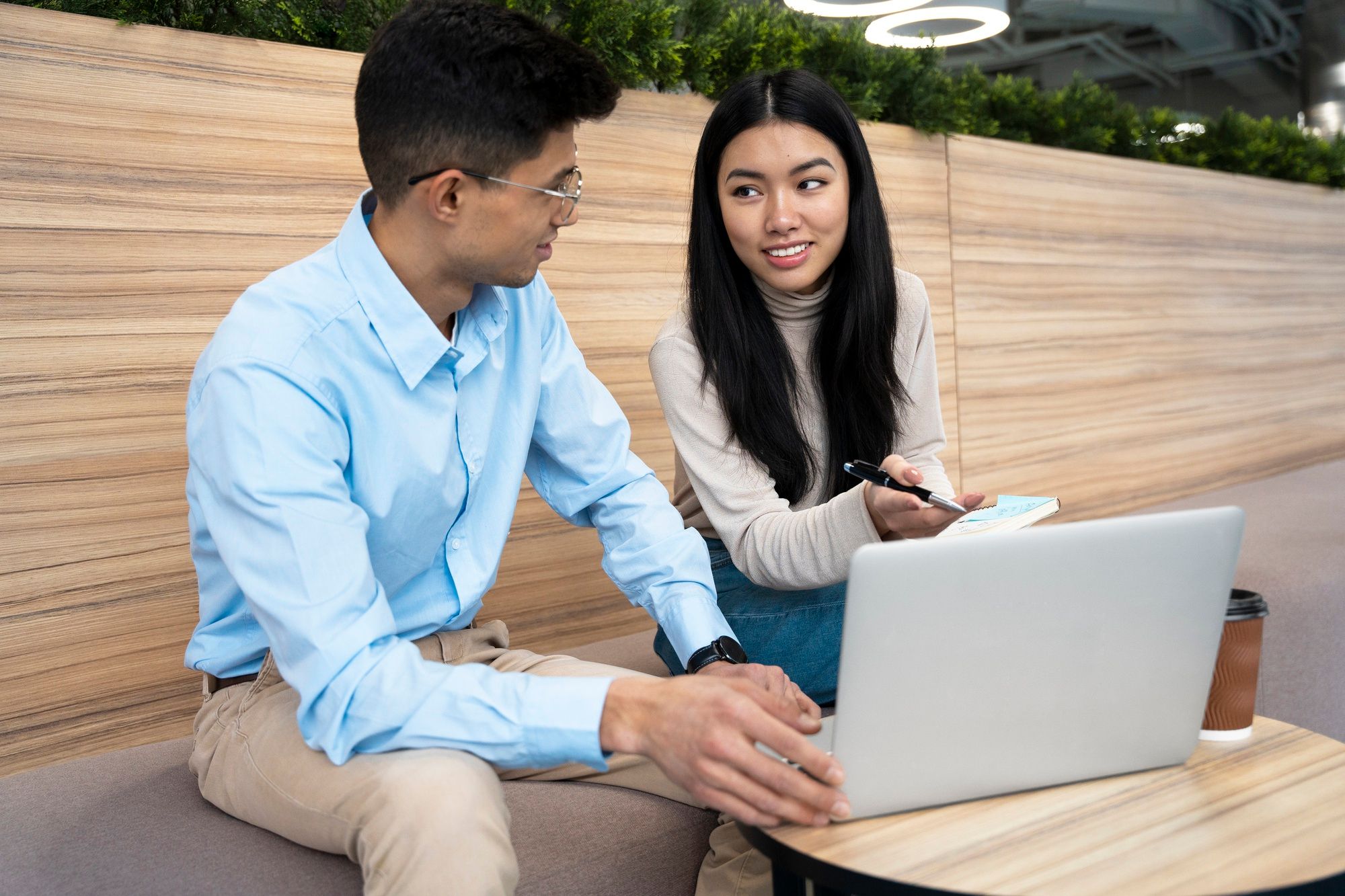 Manager giving performance review feedback to an employee during a discussion.