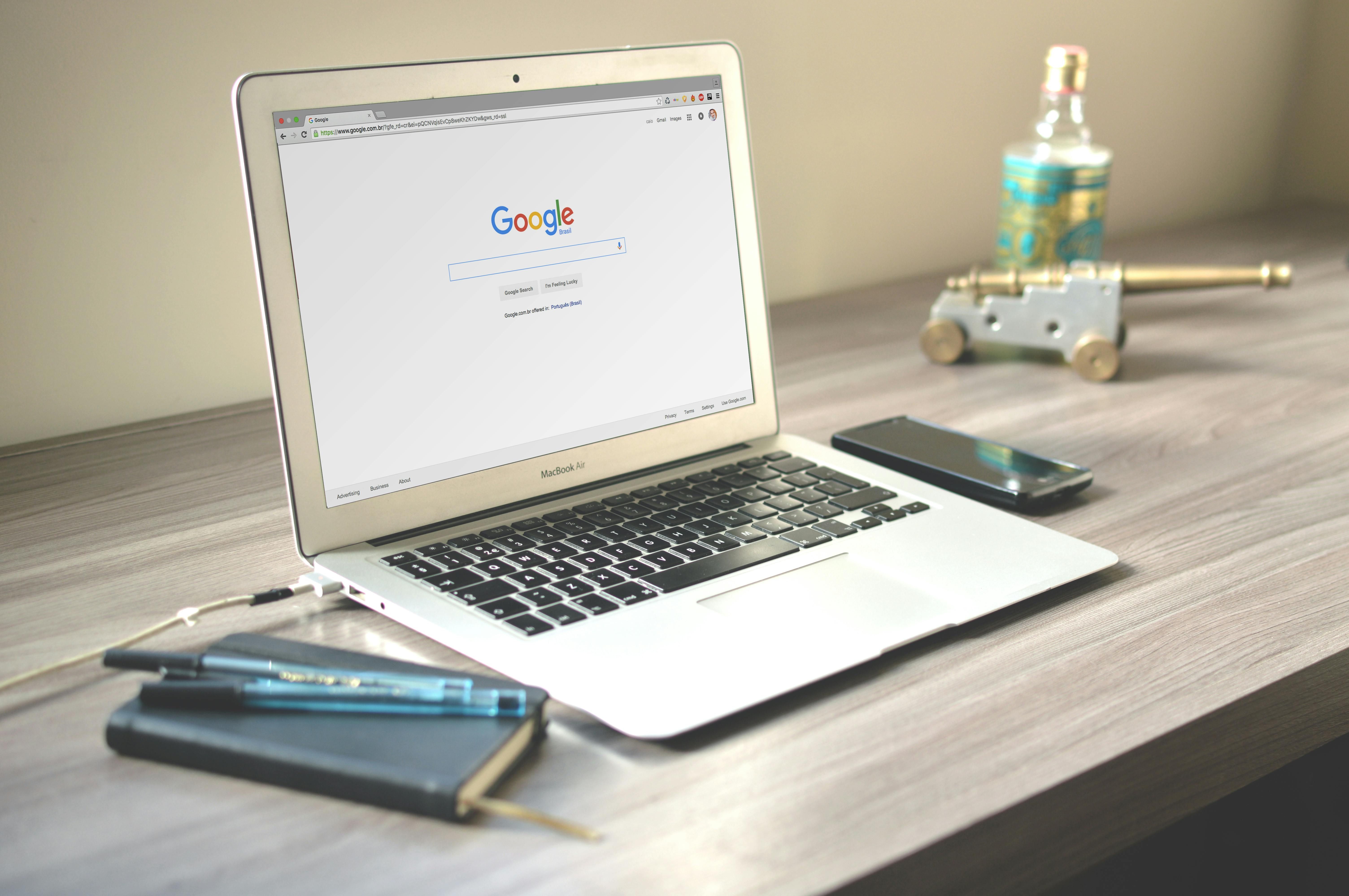 a Macbook air on grey wooden table Image by Caio with Pexels license 