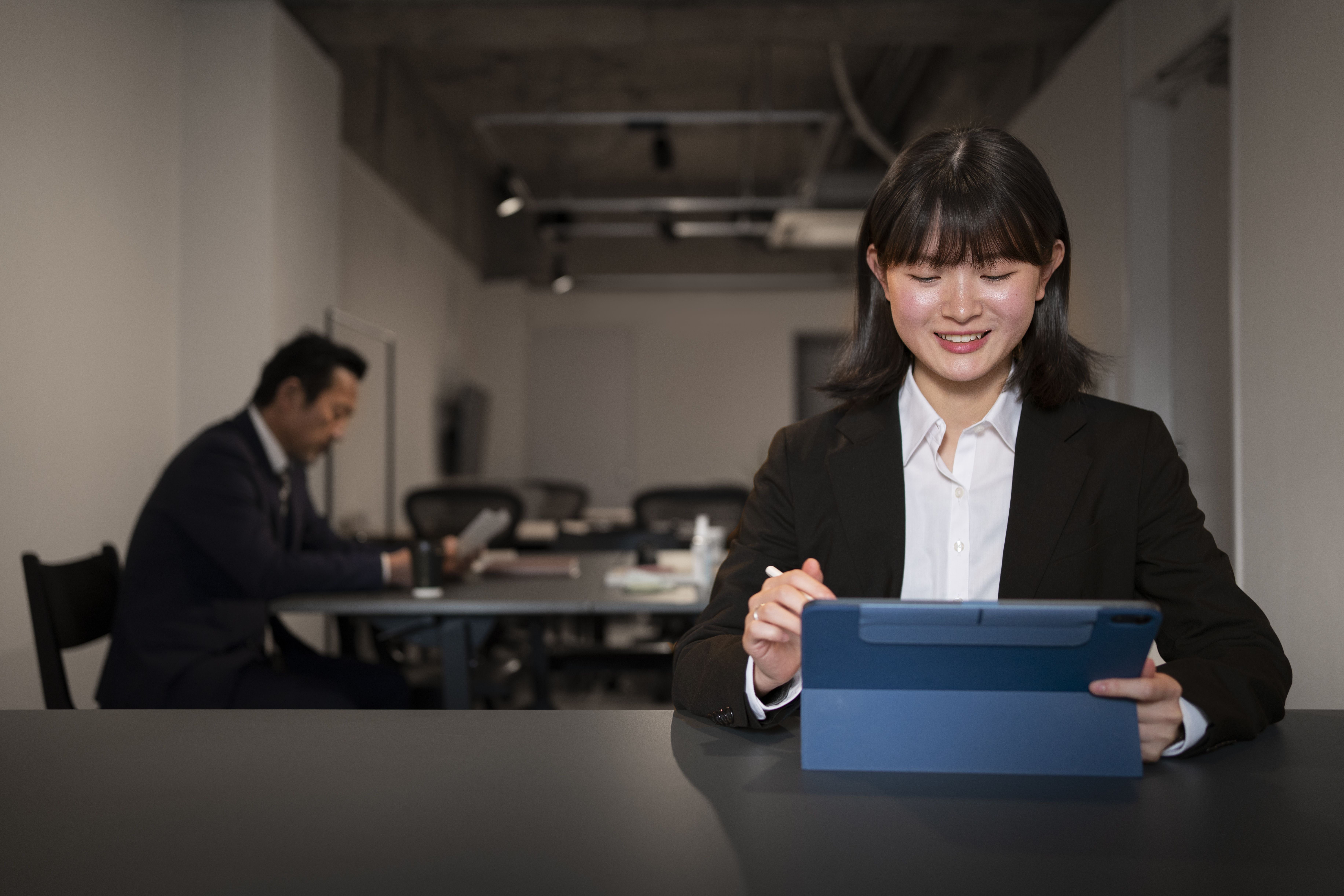 Professional preparing for a meeting, demonstrating thoughtful reflection on the best weaknesses to mention in interview.