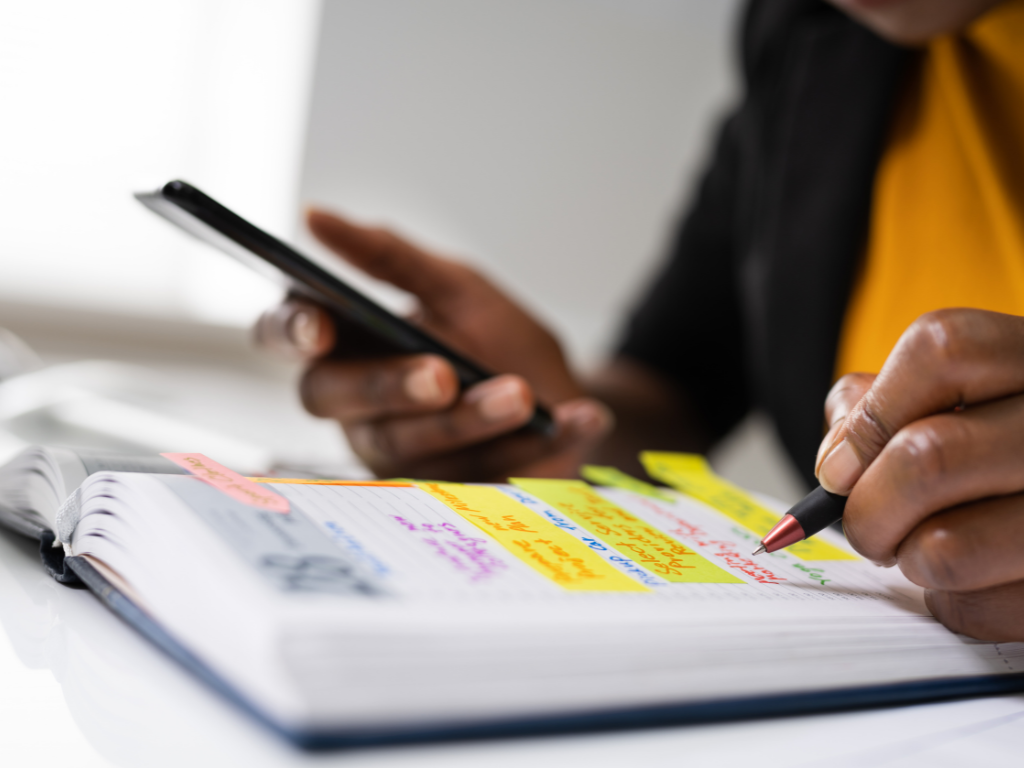 an employee writing down the agenda for an upcoming meeting