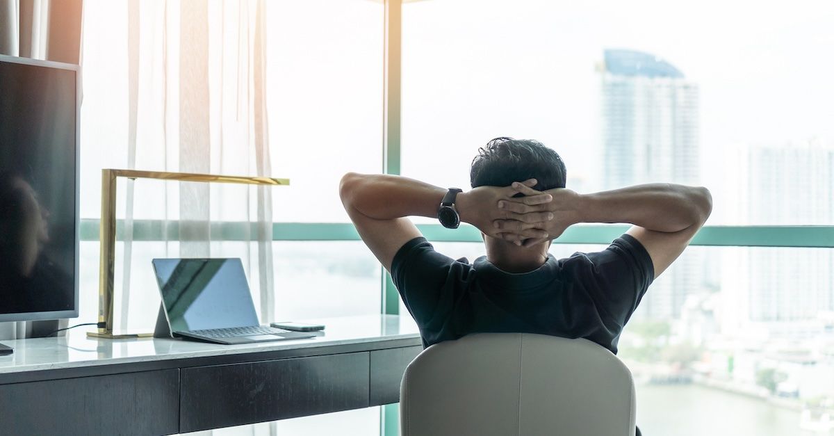 man at a desk looking out the window