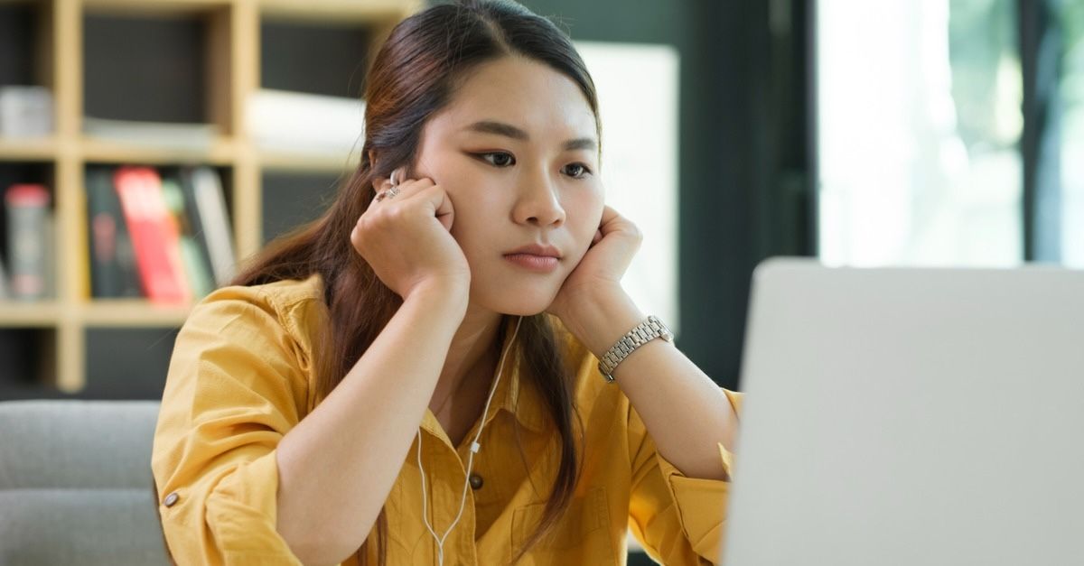 Woman stressed overwork looking at a laptop