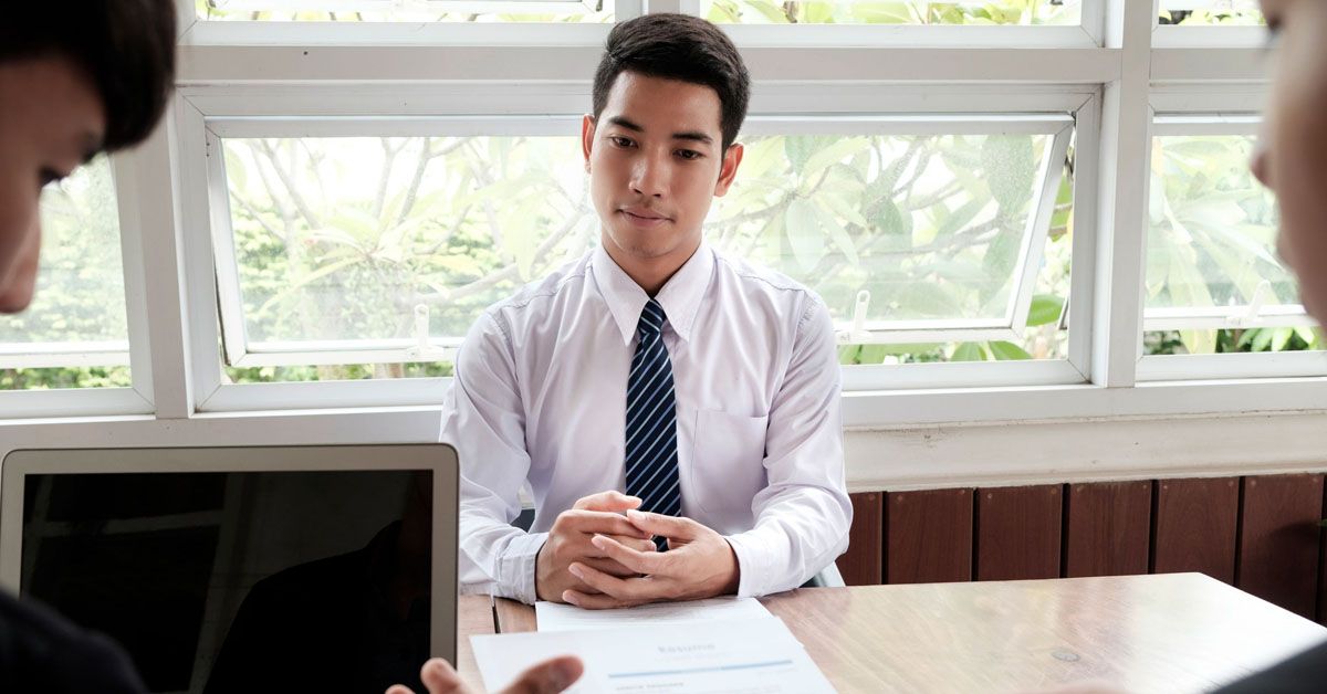 Confident guy in a job interview, dressed professionally and engaged in conversation with interviewer